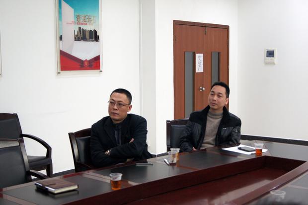 圖5、宏陶拋光磚銷售副總張彥（左一）、宏陶廣東線銷售副總龐永江（右一）認真觀看參評專賣店幻燈片播放效果